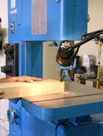 bandsaw cutting lumber